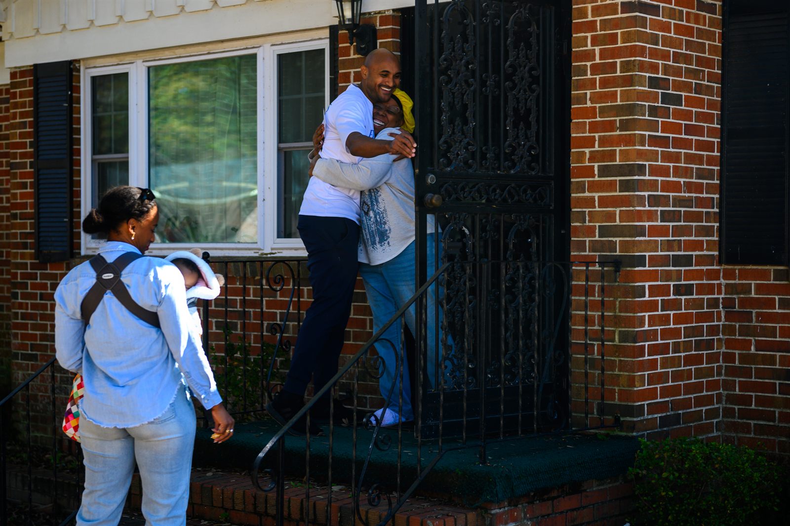 Shomari Figures greeting a constituent while canvassing in Alabama's 2nd District