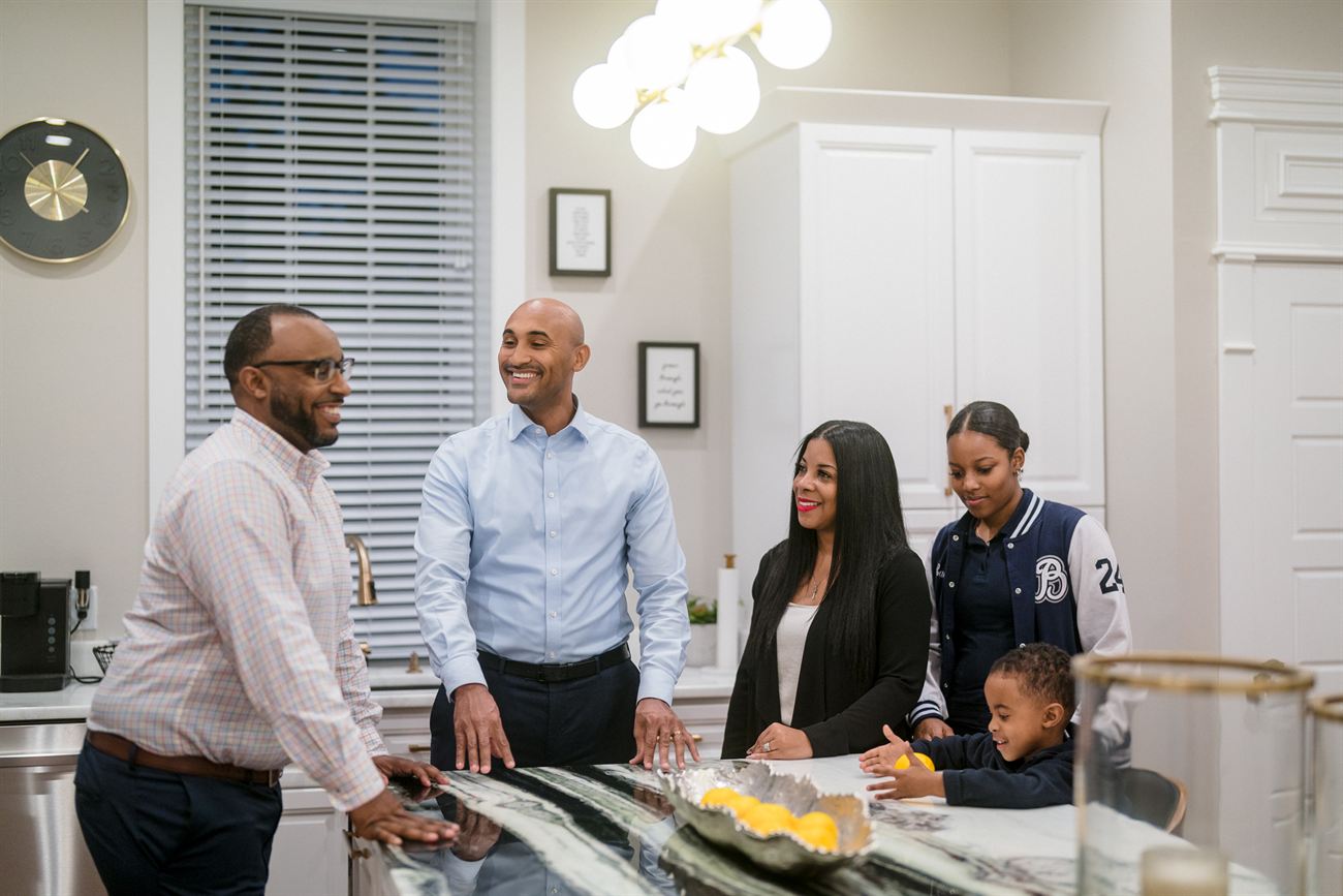 Shomari Figures with family around the kitchen
