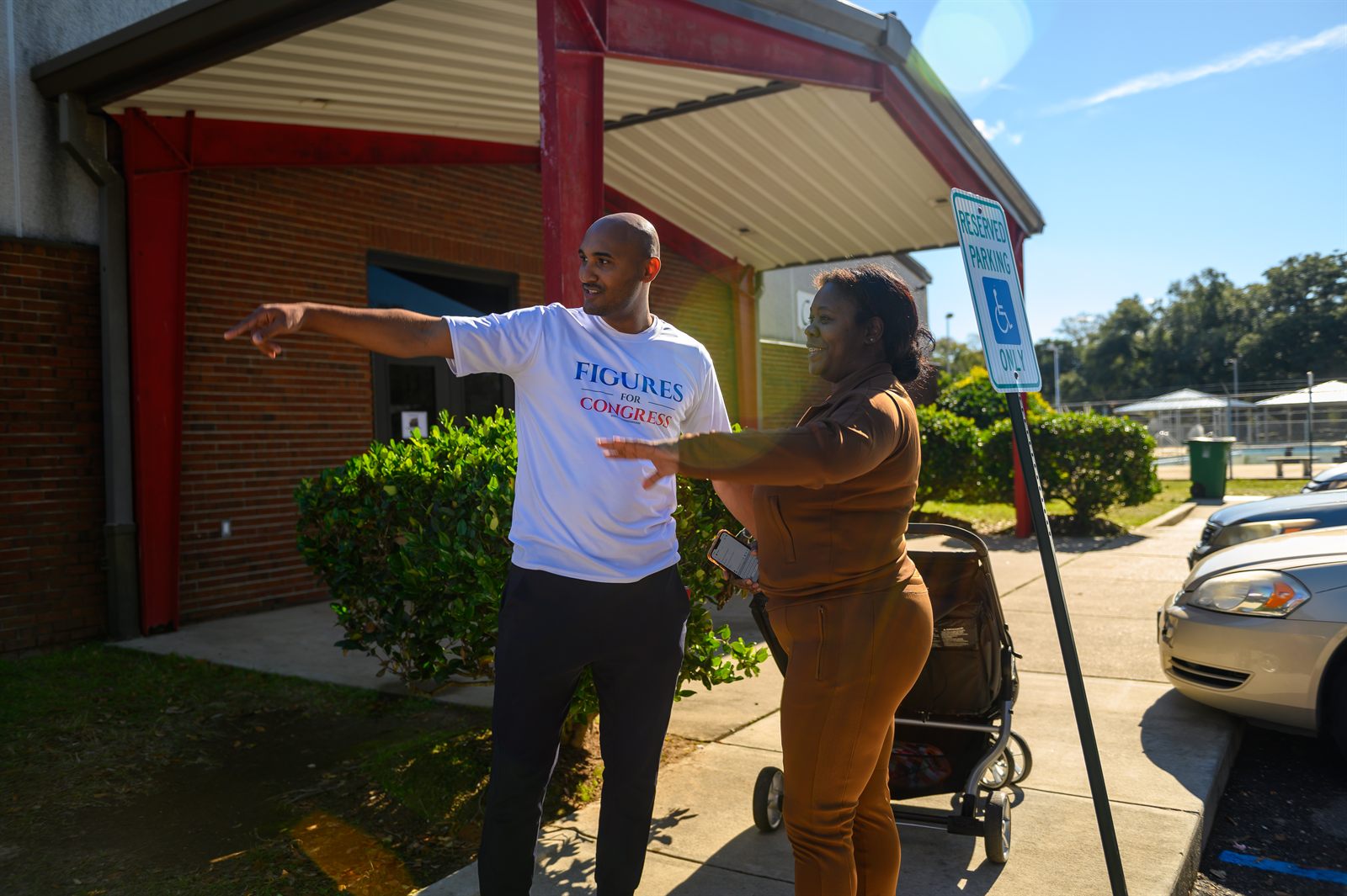 Shomari Figures talking with a voter